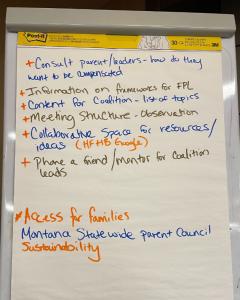 An easel shows handwritten notes from the convening about how to include parent leaders.