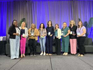 Image of nine people holding trophies after winning the Betty Tableman Award.